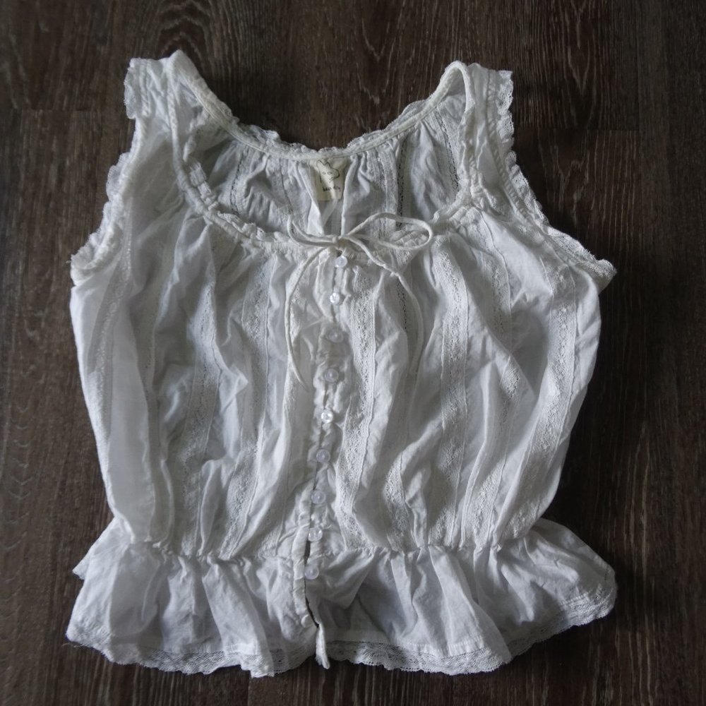 White sleeveless eyelet blouse